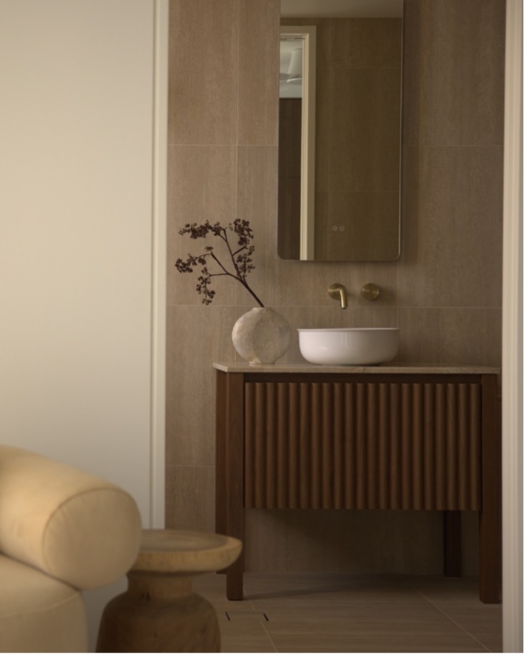 Contemporary bathroom vanity with coordinated tapware and stone benchtop in a renovated space