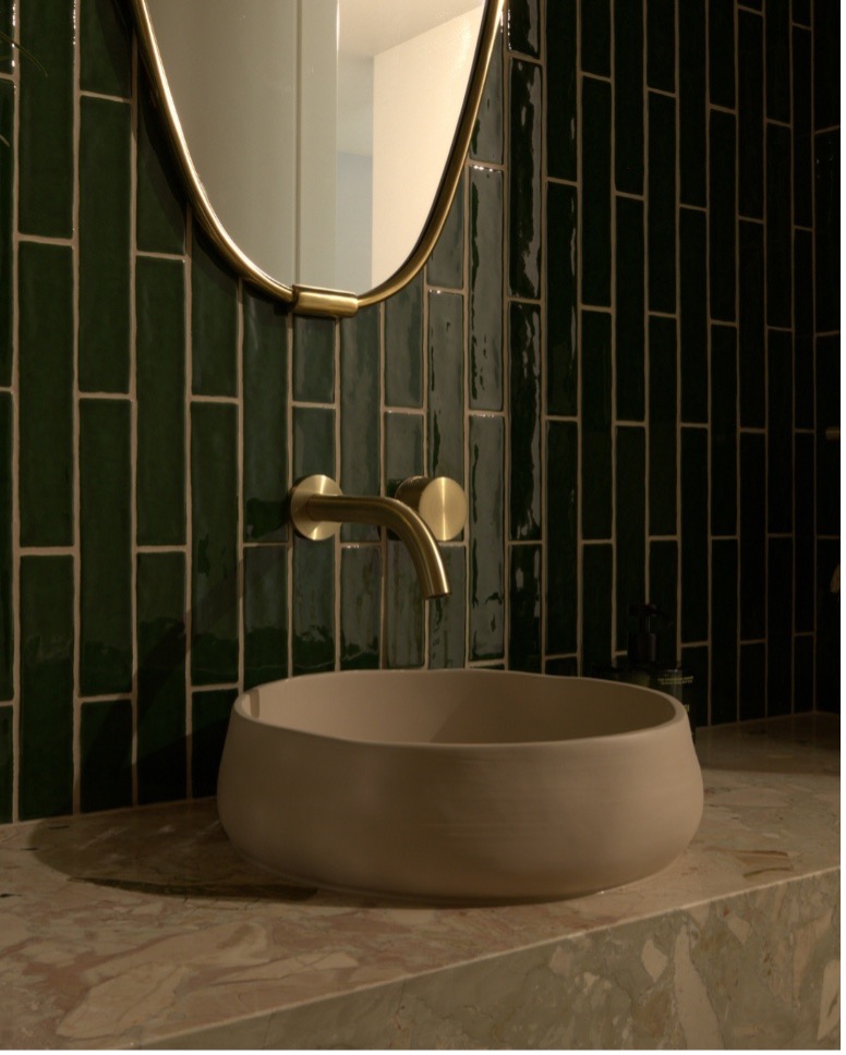 Freestanding bath with floor-mounted bath filler and soft neutral palette in a renovated bathroom
