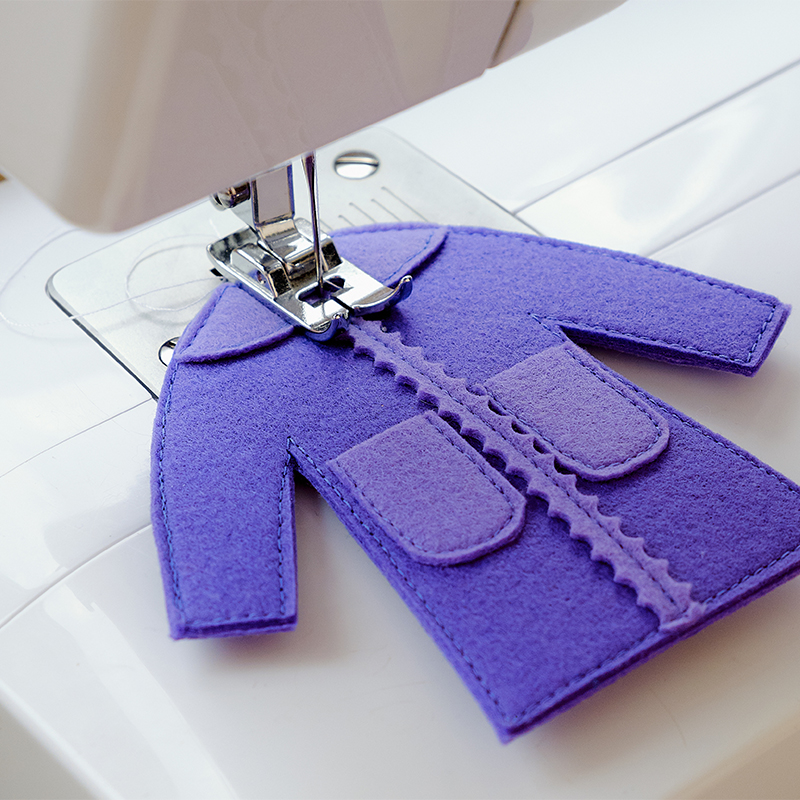 Small felt dress and sewing machine
